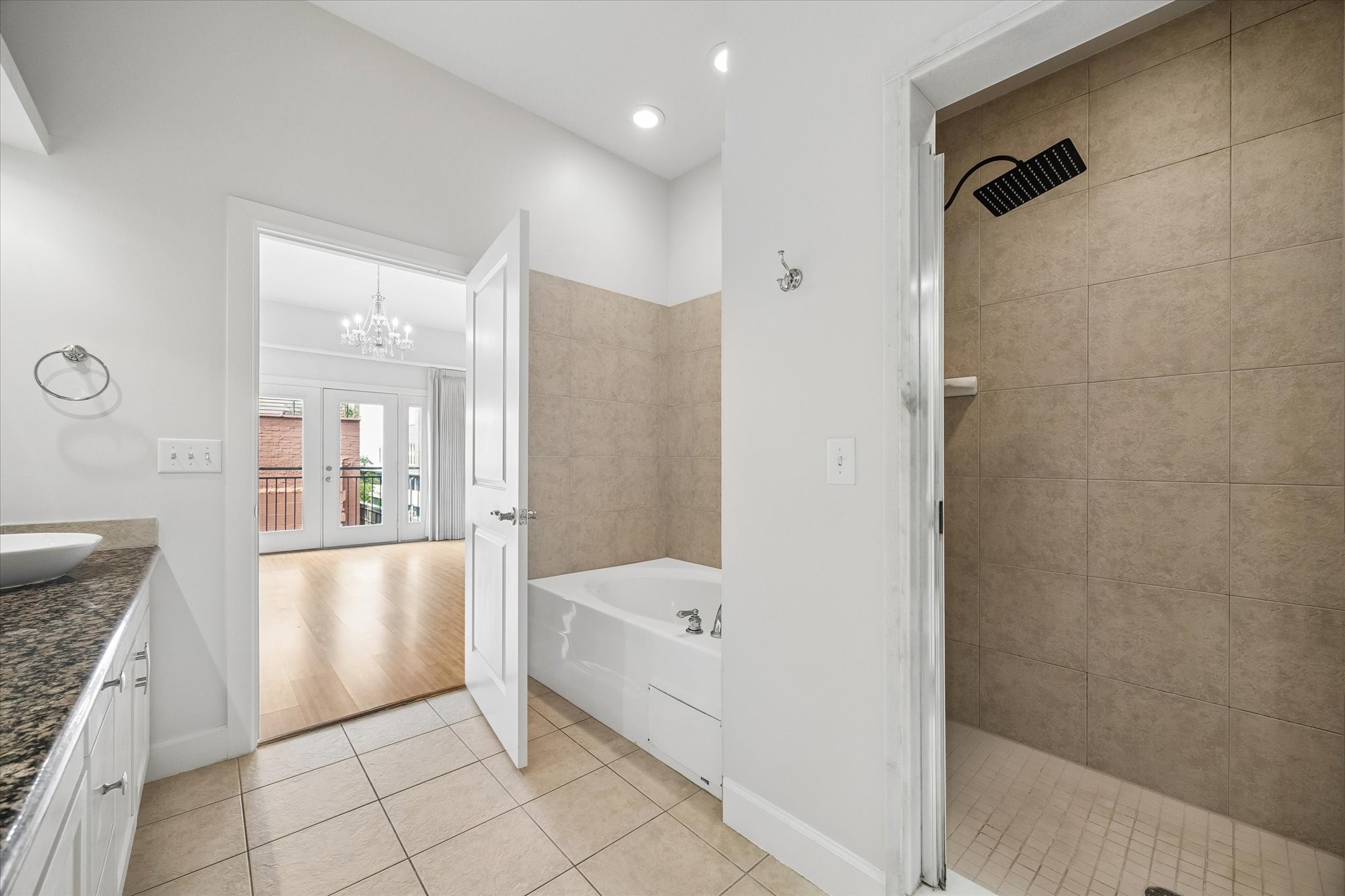 100 Willard Street, Unit 15 Houston, TX 77006 - Photo 16 of 25 The primary bathroom offers both a large soaking tub and separate shower enclosure, creating a comfortable retreat with functional everyday luxury.