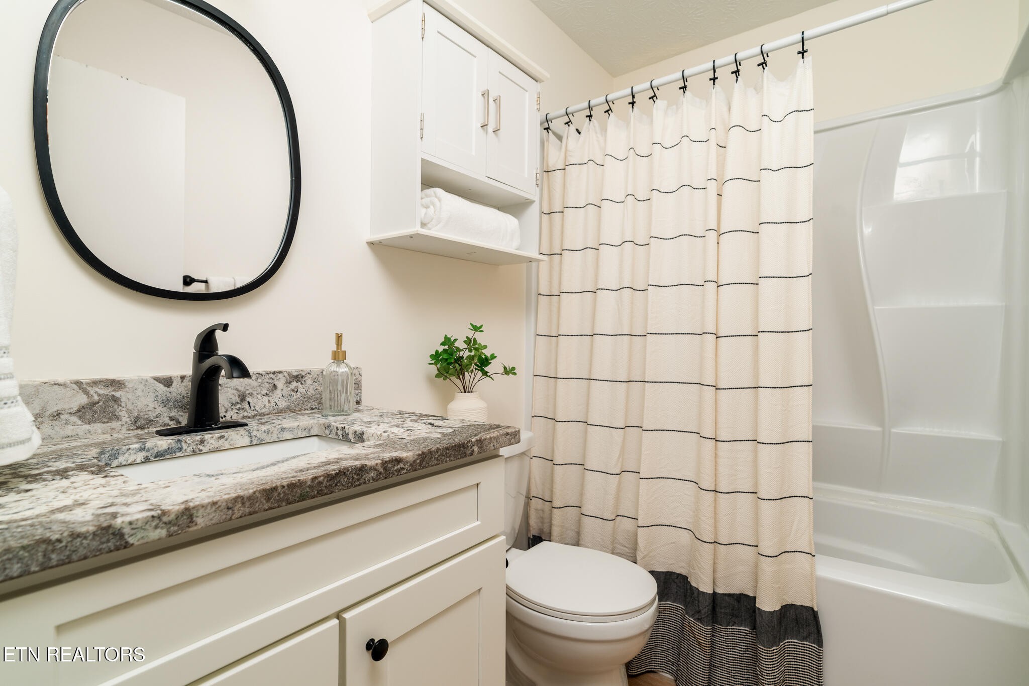 520 Harrow Road Knoxville, TN 37934 - Photo 19 of 42 a bathroom with a granite countertop sink a toilet and a mirror