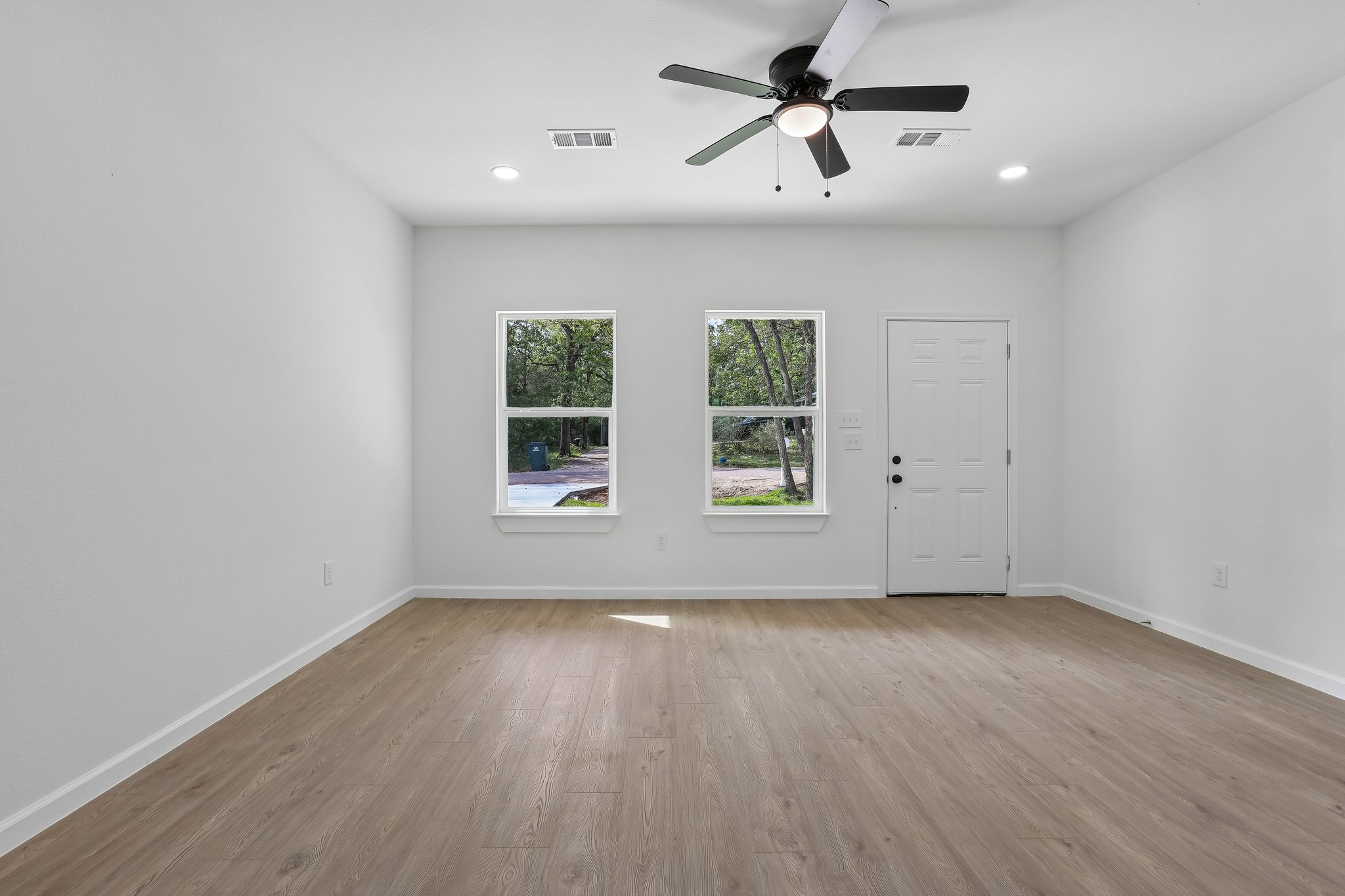 210 Flint Ridge Street Bastrop, TX 78602 - Photo 6 of 40 wooden floor in an empty room with a window