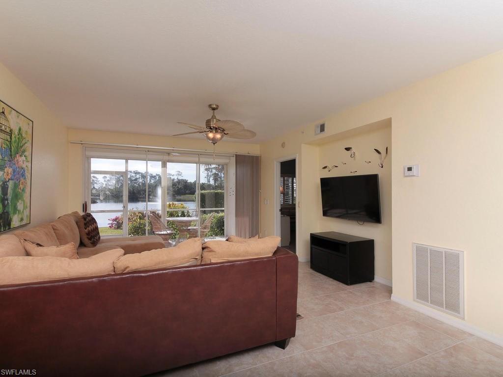 550 Gabriel Circle, Unit 3111 Naples, FL 34104 - Photo 11 of 25 a living room with furniture and a flat screen tv