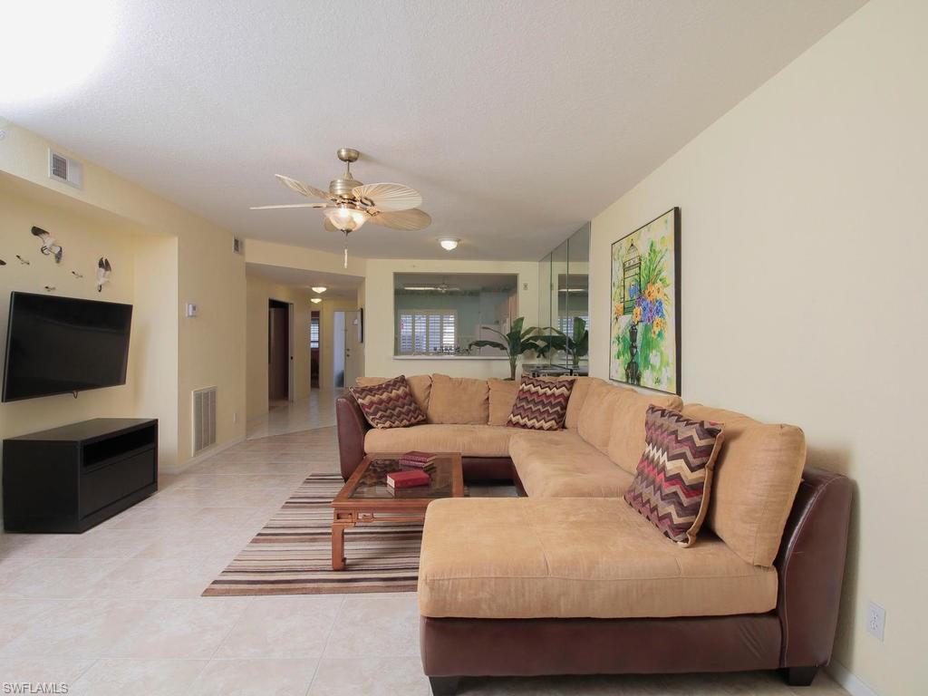 550 Gabriel Circle, Unit 3111 Naples, FL 34104 - Photo 12 of 25 a living room with furniture and a flat screen tv