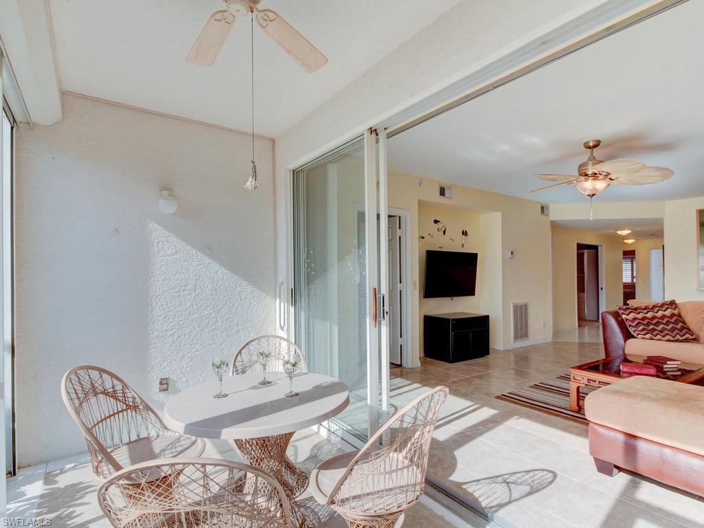 550 Gabriel Circle, Unit 3111 Naples, FL 34104 - Photo 14 of 25 a bedroom with furniture and a flat screen tv