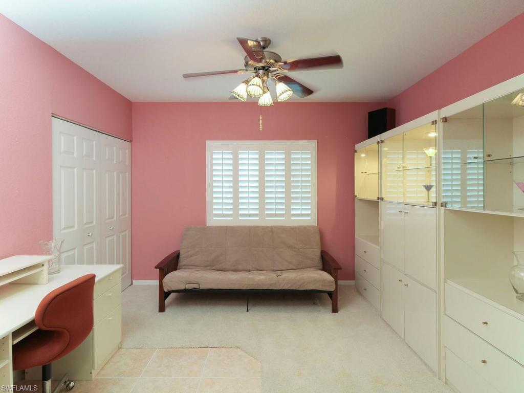 550 Gabriel Circle, Unit 3111 Naples, FL 34104 - Photo 19 of 25 a bedroom with a bed and a chandelier