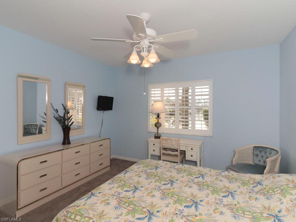 550 Gabriel Circle, Unit 3111 Naples, FL 34104 - Photo 21 of 25 a bedroom with a large bed and a window
