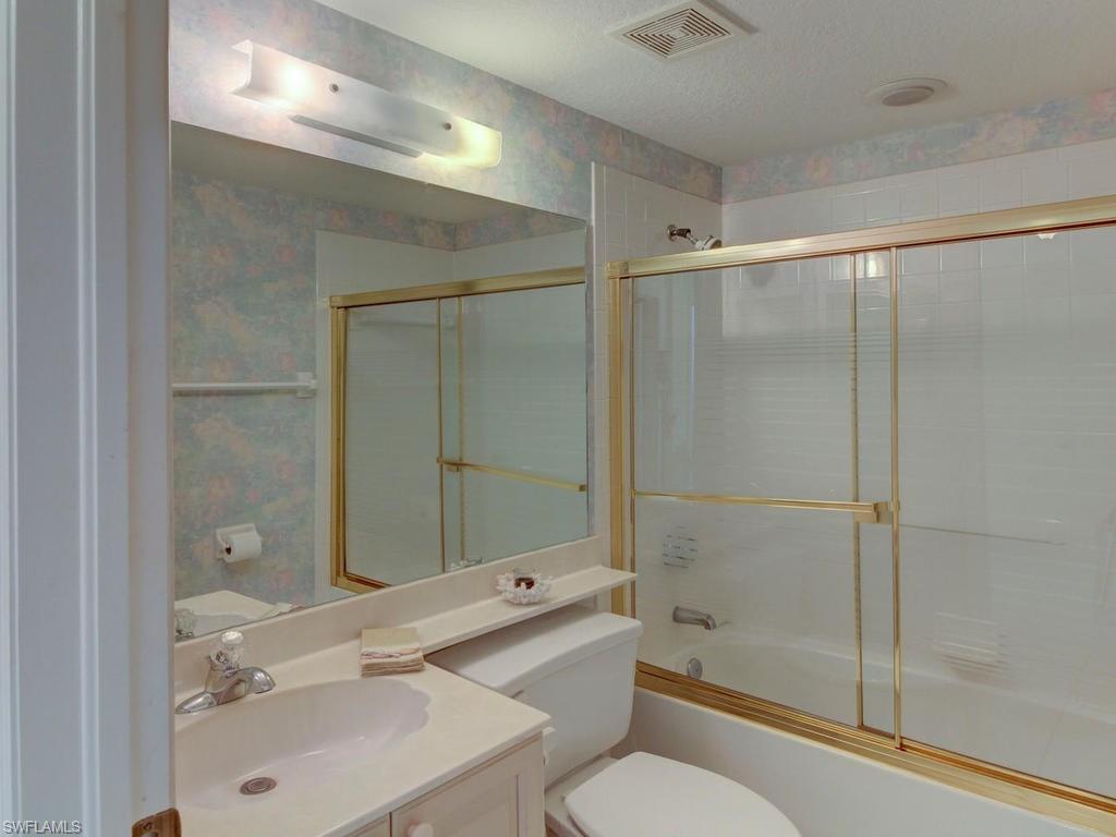 550 Gabriel Circle, Unit 3111 Naples, FL 34104 - Photo 4 of 25 a bathroom with a sink mirror toilet and bathtub