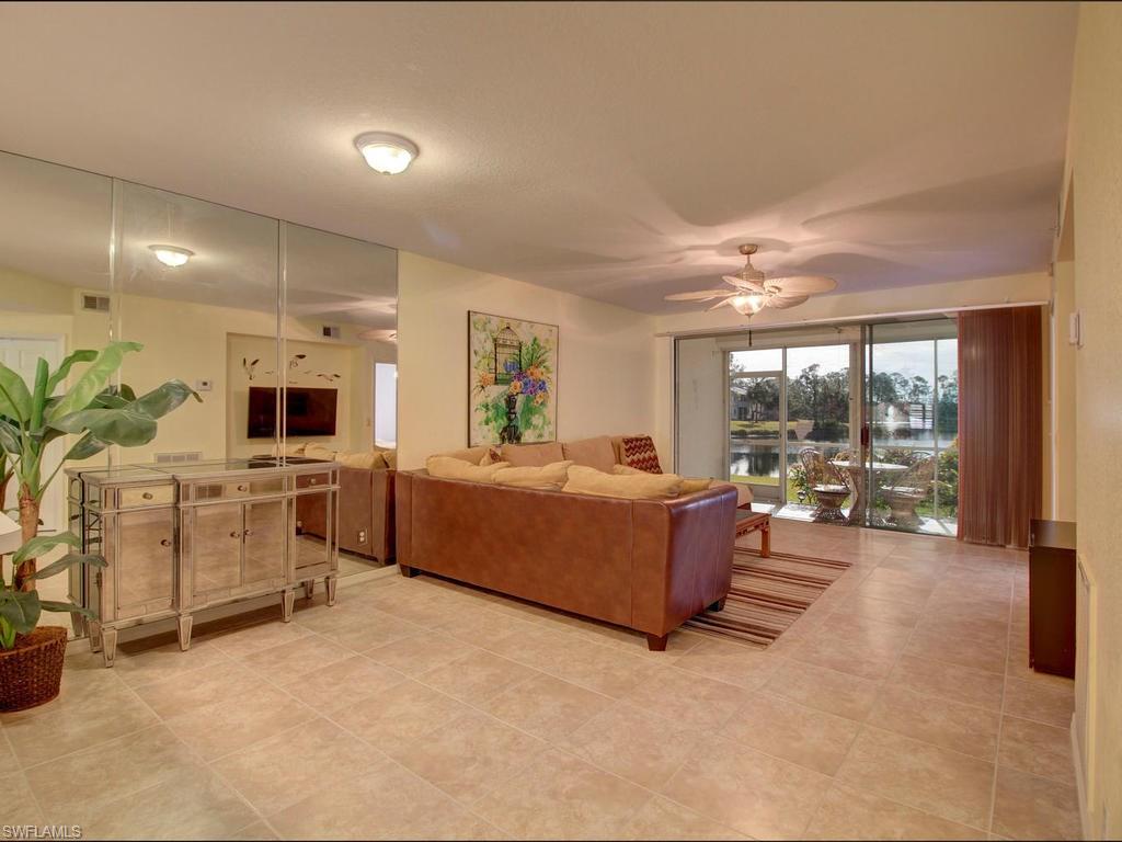550 Gabriel Circle, Unit 3111 Naples, FL 34104 - Photo 9 of 25 a living room with furniture and a large window