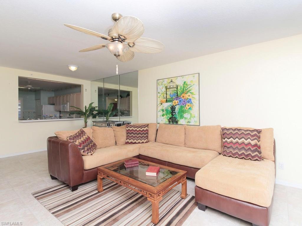 550 Gabriel Circle, Unit 3111 Naples, FL 34104 - Photo 10 of 25 a living room with couches and a coffee table with wooden floor