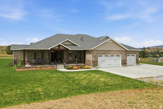 3123 East Riverdale Road Preston, ID 83263 - Photo 1 of 52 Ranch-style residence featuring a covered front porch, a three-car garage, and a concrete driveway