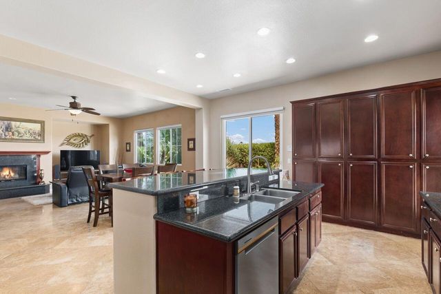 a kitchen with sink refrigerator and couches