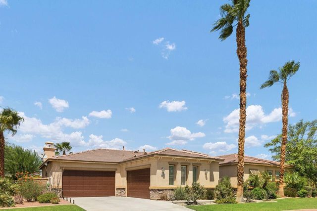 a front view of a house with a garden and plants