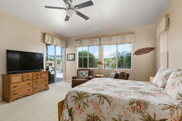 a bedroom with furniture and a flat screen tv