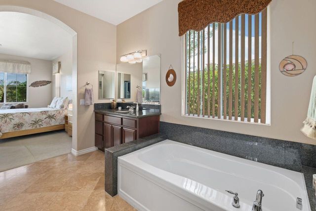 a en suite bathroom with a sink and a large mirror
