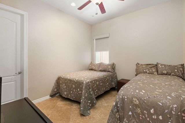 a bedroom with two beds and painted walls