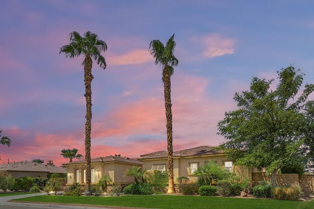 a front view of a residential apartment building with a yard