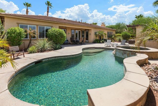 a view of a house with swimming pool and porch