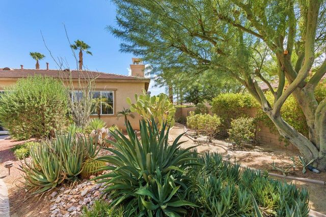a view of a house with a tree