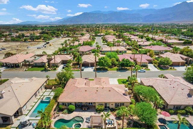 an aerial view of residential houses with outdoor space and river