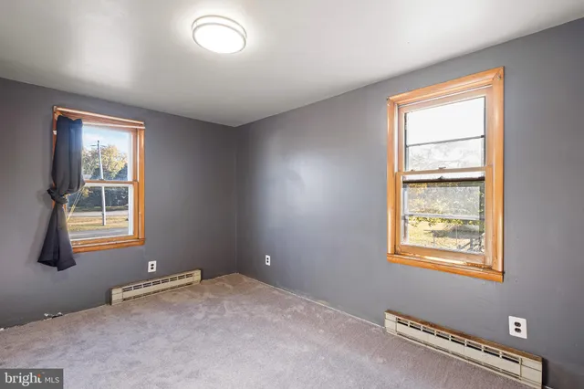 a room with a window and a projector screen