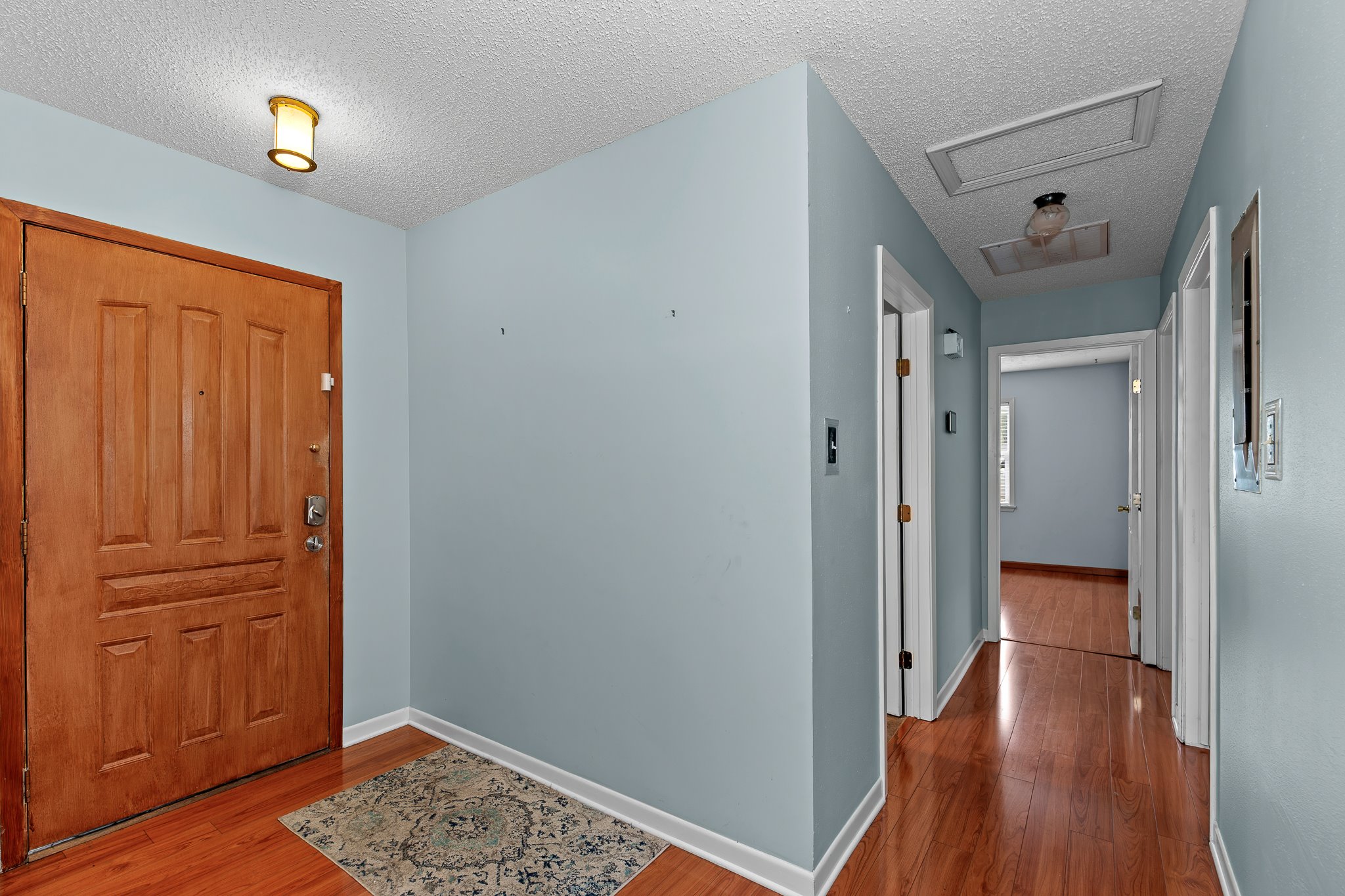 5600 Libyan Circle Austin, TX 78745 - Photo 5 of 37 Foyer featuring light wood-type flooring and a textured ceiling