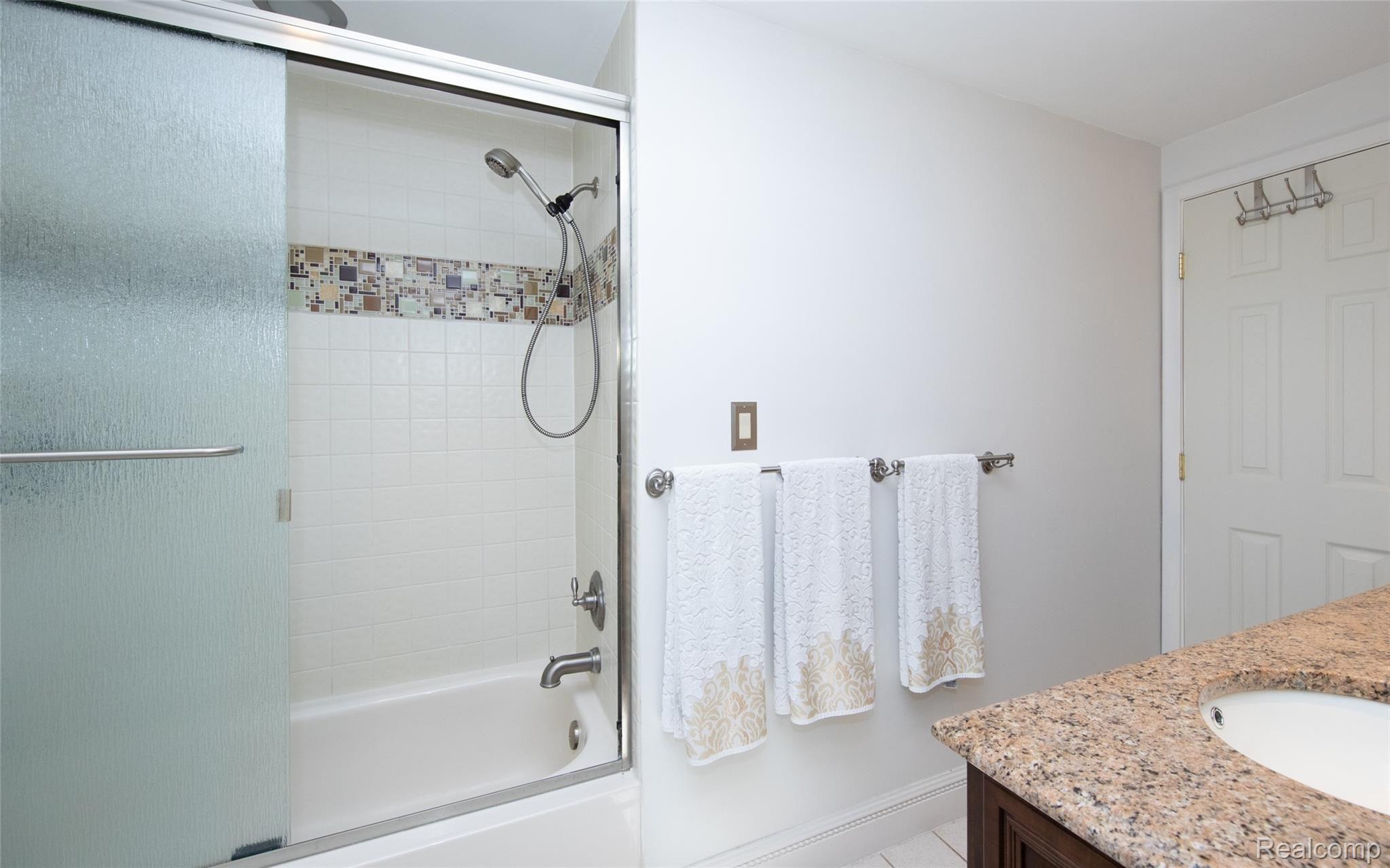 8117 Reese Road Clarkston, MI 48348 - Photo 32 of 41 Second view of full bath upstairs. Enjoy the luxury of a bathtub and a shower in one complete with privacy glass for added comfort.