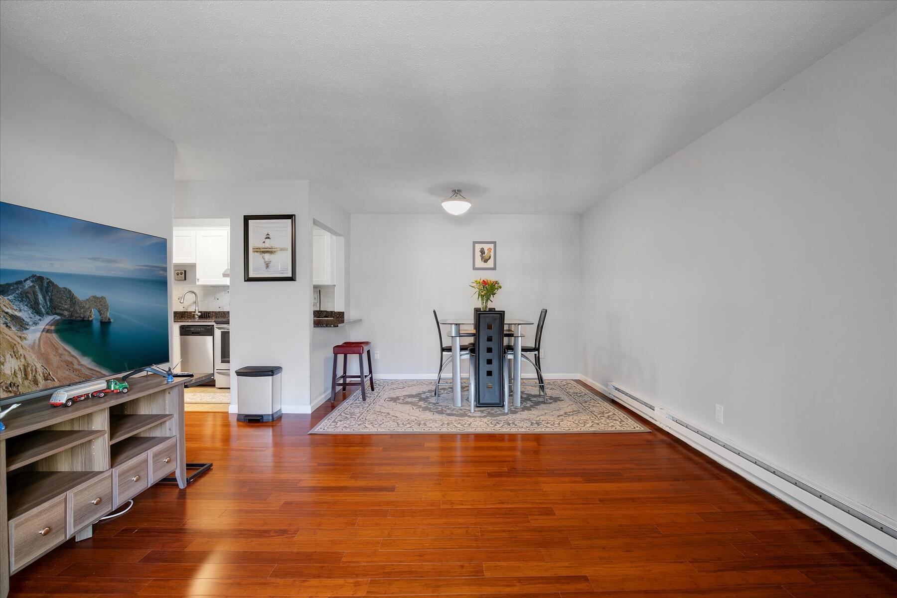 800 Bearses Way, Unit 1EB Hyannis, MA 02601 - Photo 8 of 37 a room with lots of furniture and wooden floor