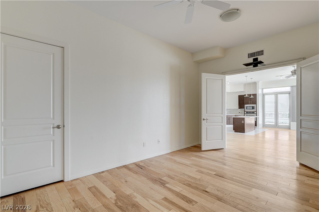 360 East Desert Inn Road, Unit 402 Las Vegas, NV 89109 - Photo 14 of 40 Warm hardwood flooring flows throughout this adaptable living area.