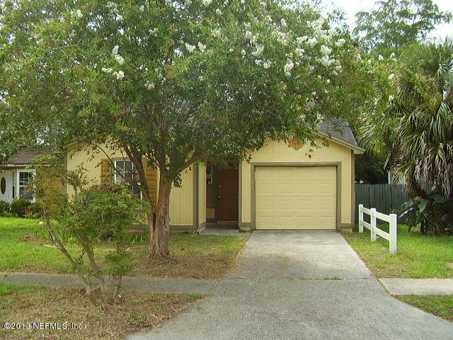 2465 Wattle Tree Road East Jacksonville, FL 32246 - Photo 1 of 11 a front view of a house with a yard and garage