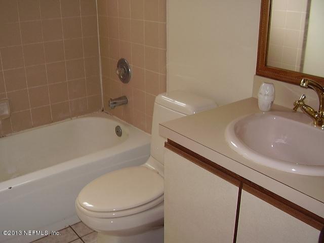 2465 Wattle Tree Road East Jacksonville, FL 32246 - Photo 4 of 11 a white bath tub sitting next to a white toilet