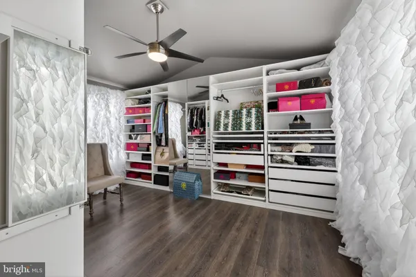 a bathroom with a tub a sink and mirror