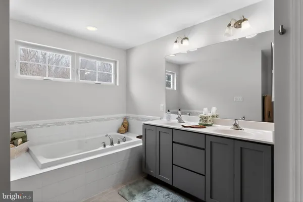 a bathroom with a shower sink double and mirror