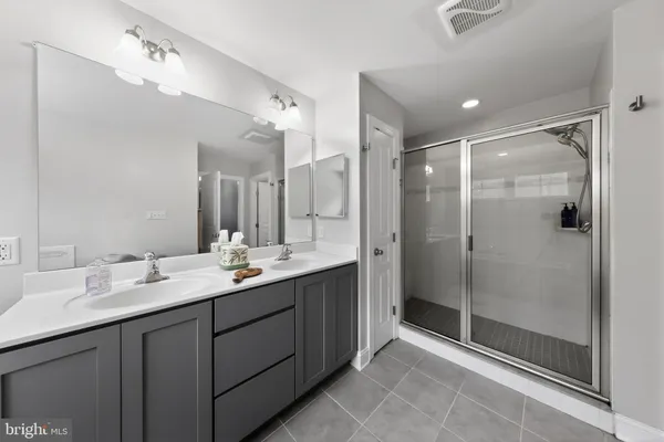 a bathroom with a sink double vanity and a mirror