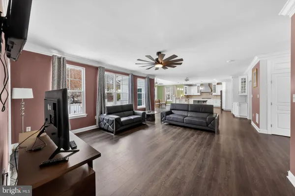 a living room with furniture gym equipment and a large window