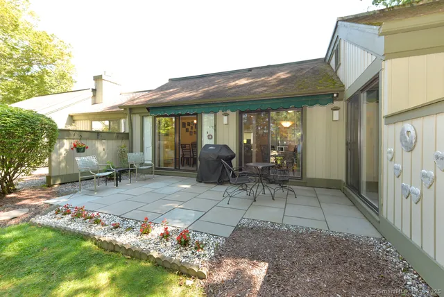 a view of a patio with table and chairs and potted plants