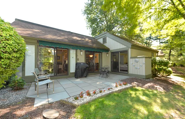 a view of a house with backyard porch and sitting area