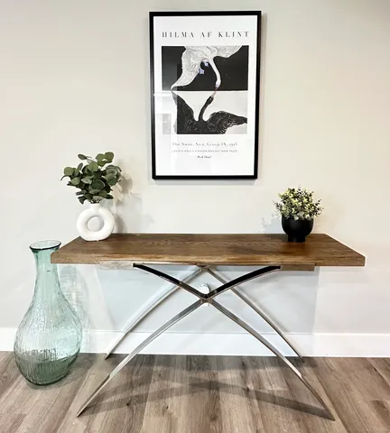 a table with a vase and flowers on it