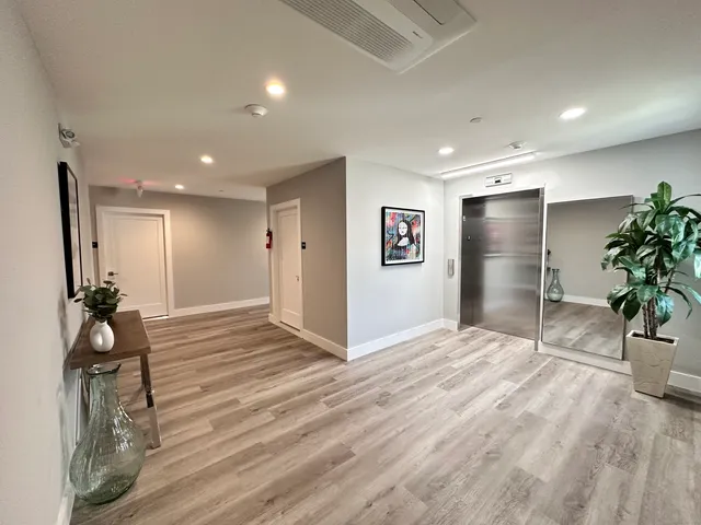 a view of an empty room with potted plants