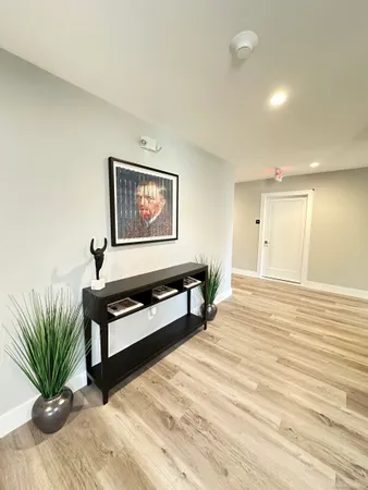 a view of workspace filled with furniture and wooden floor