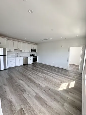 a view of kitchen and wooden floor
