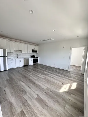 a view of kitchen and wooden floor