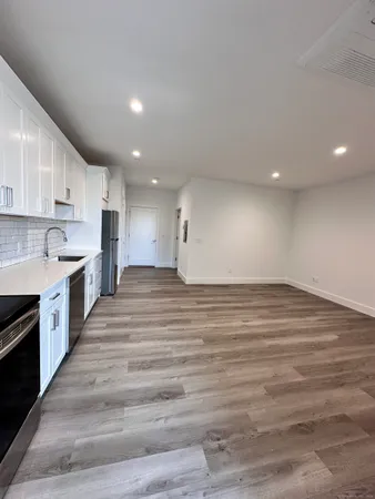 a view of kitchen with wooden floor and electronic appliances
