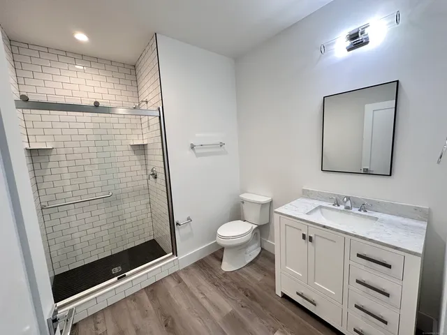 a bathroom with a toilet sink and shower