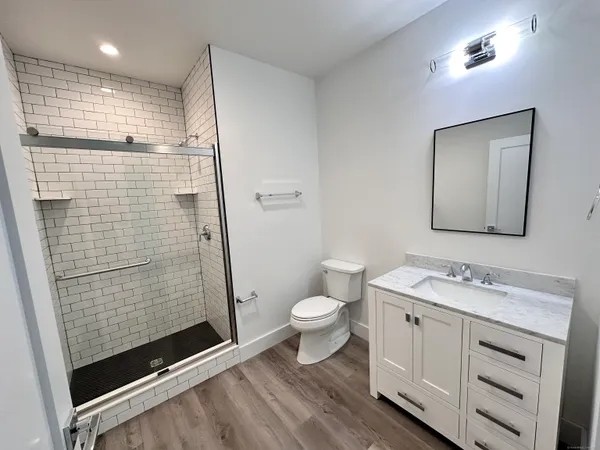a bathroom with a toilet sink and shower