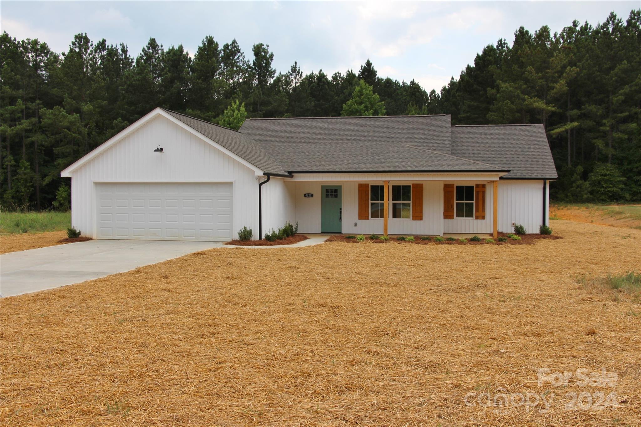 4222 Fletcher Funderburk Road Lancaster, SC 29720 - Photo 3 of 18 a front view of a house with a yard and garage