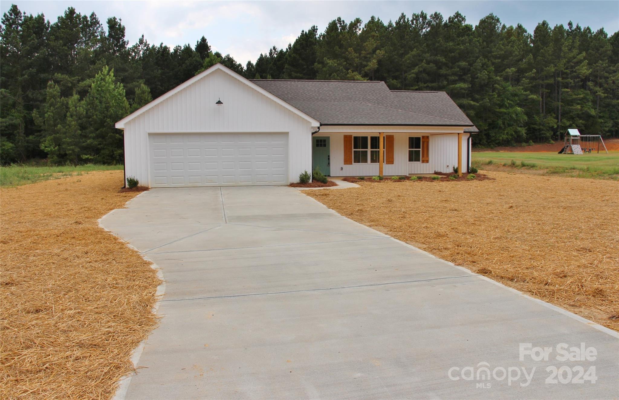 4222 Fletcher Funderburk Road Lancaster, SC 29720 - Photo 4 of 18 a front view of a house with a yard and garage