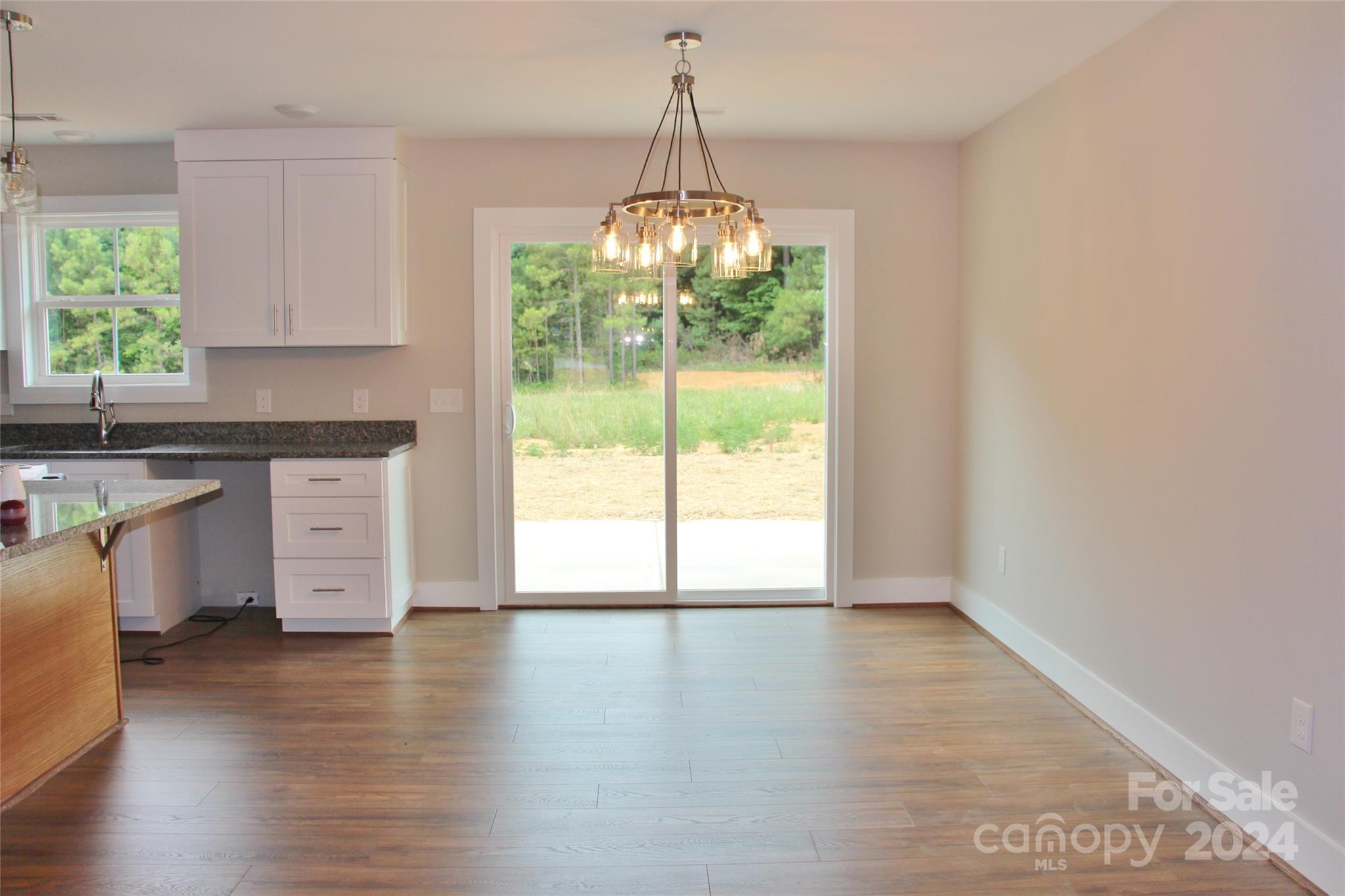 4222 Fletcher Funderburk Road Lancaster, SC 29720 - Photo 8 of 18 a view of an empty room with a window and wooden floor