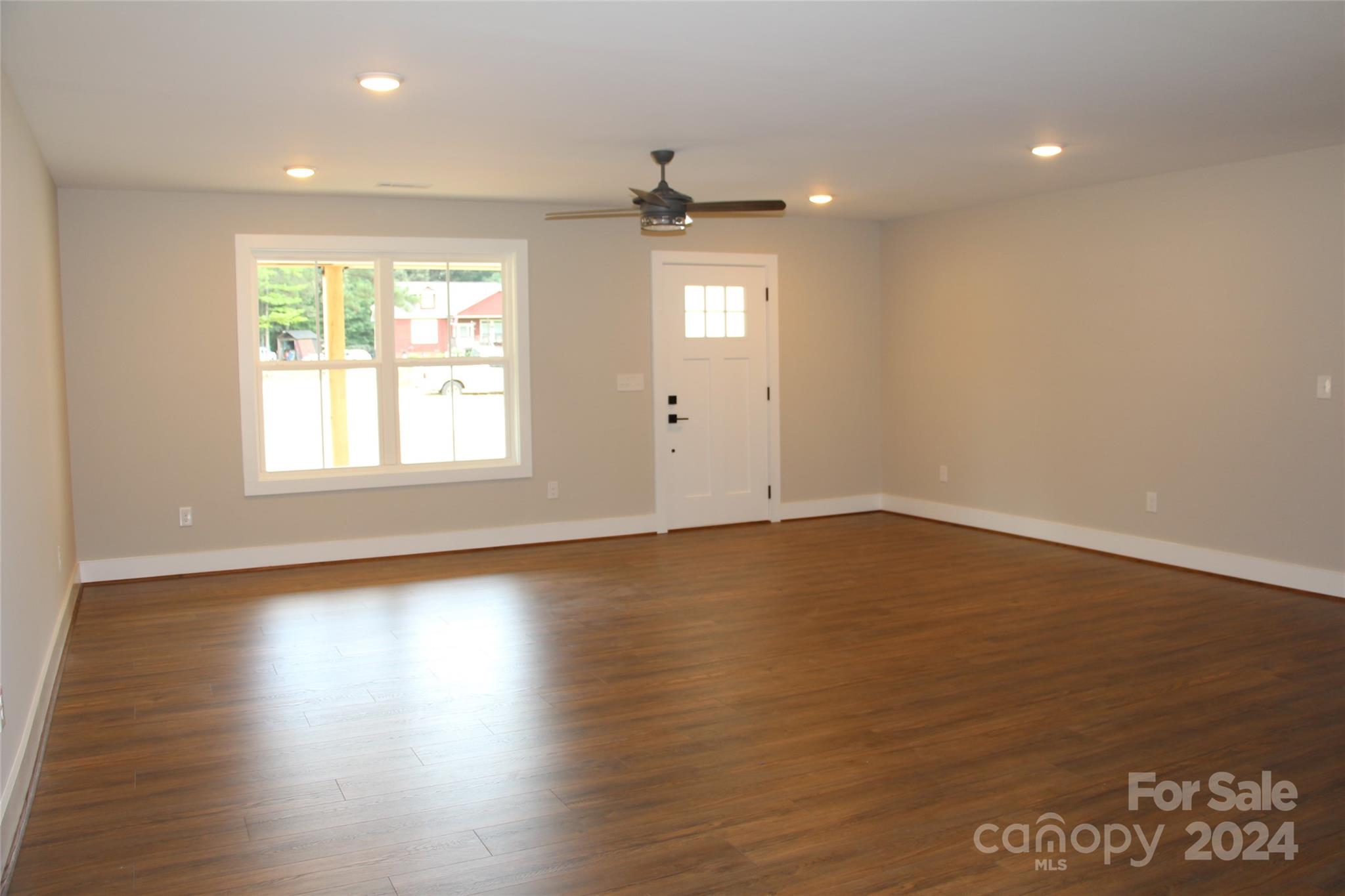 4222 Fletcher Funderburk Road Lancaster, SC 29720 - Photo 9 of 18 an empty room with wooden floor and windows
