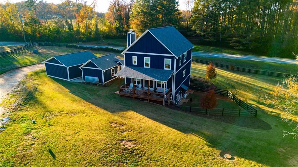 564 Old Airport Road Commerce, GA 30530 - Photo 37 of 39 a view of a house with a big yard potted plants and large tree