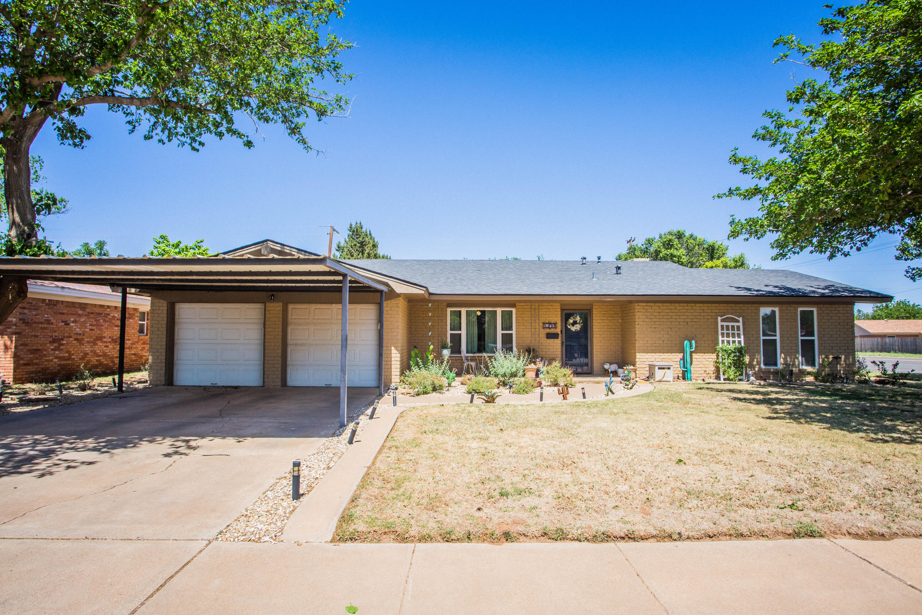 a front view of a house with a yard outdoor seating and garage
