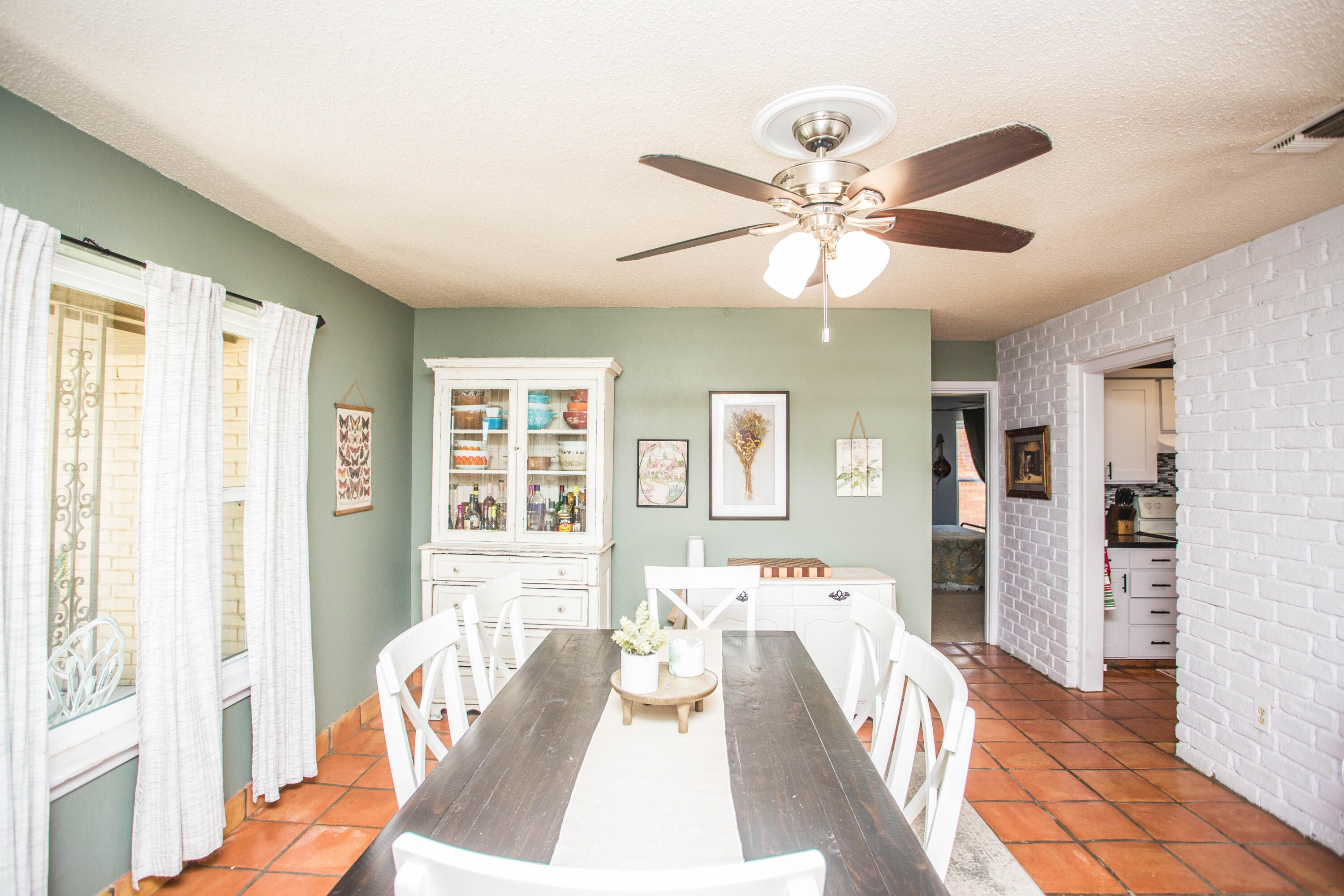 5202 44th Street Lubbock, TX 79414 - Photo 14 of 51 a spacious bedroom with a large bed and a chandelier