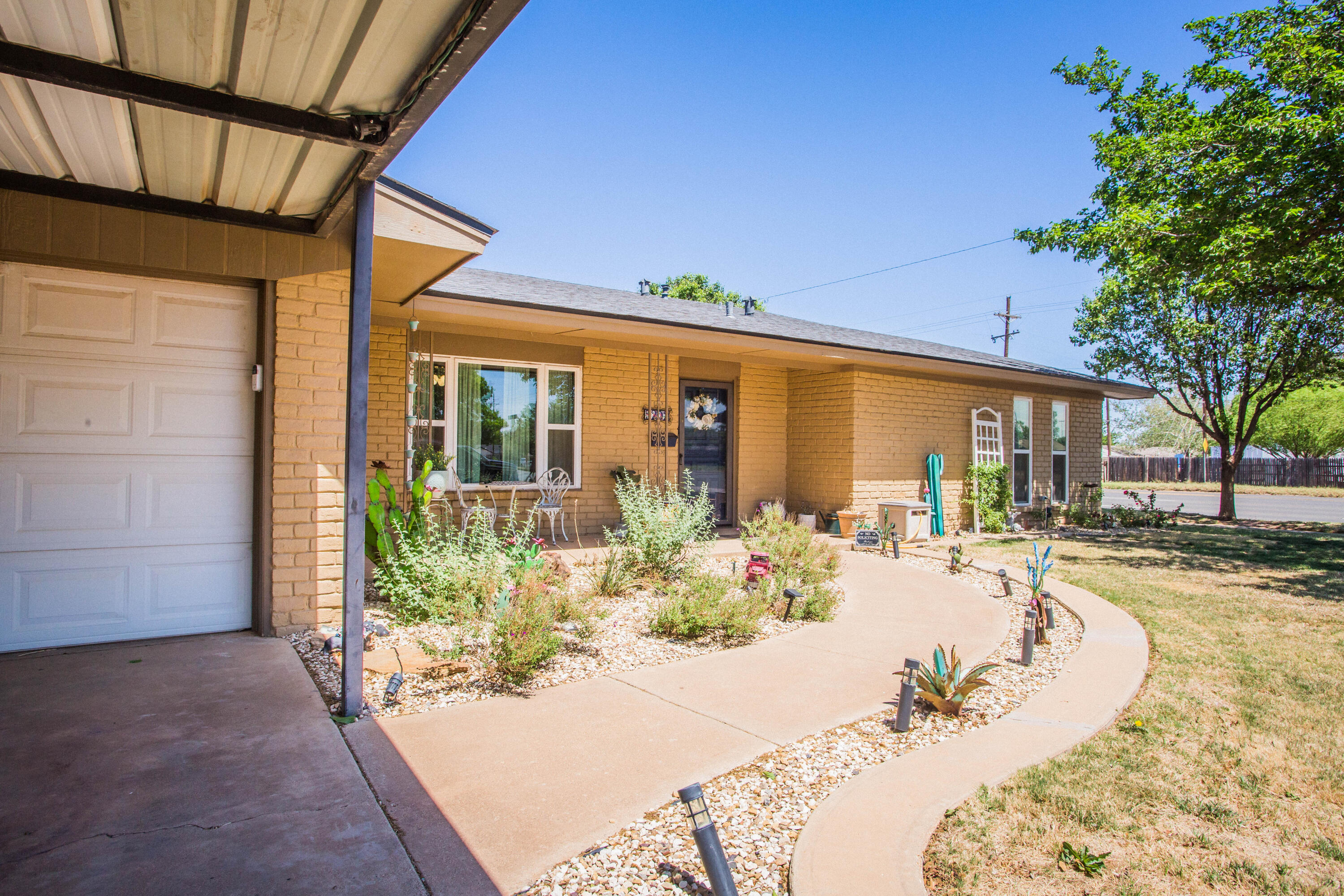 5202 44th Street Lubbock, TX 79414 - Photo 2 of 51 a view of a swimming pool with potted plants